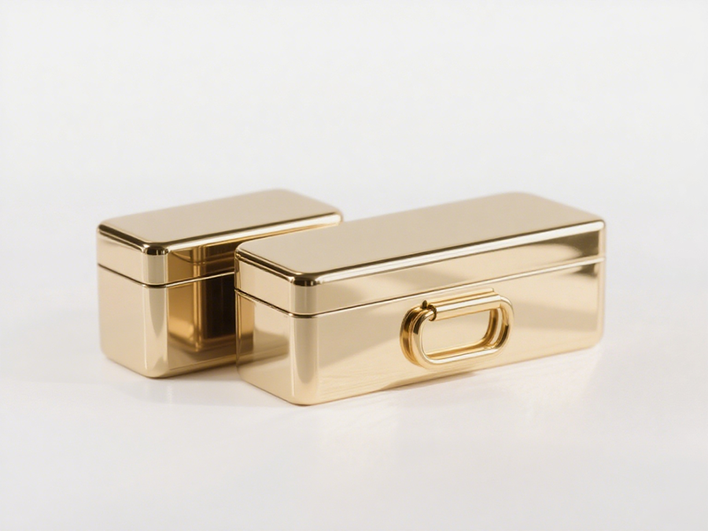 Rectangular golden box, polished glossy surface, with a ring-shaped metal handle on the right, simple, practical and high-end.